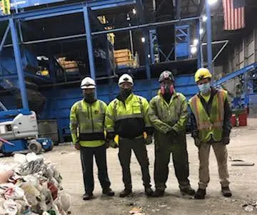 Cleaning technicians in a waste recycling center.